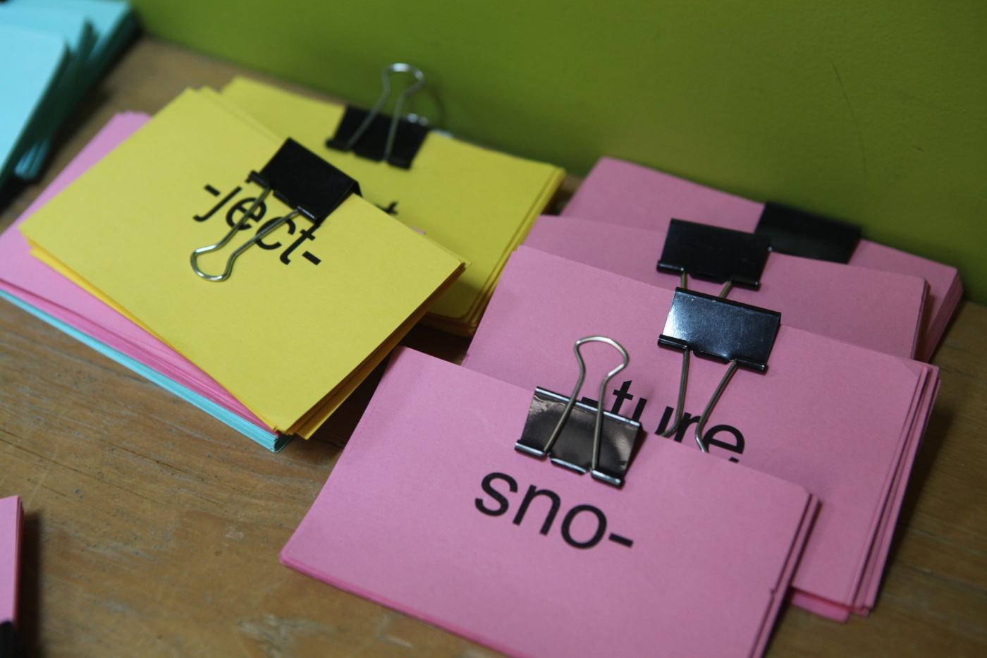 Color-coded suffix cards laid out during a structured literacy lesson