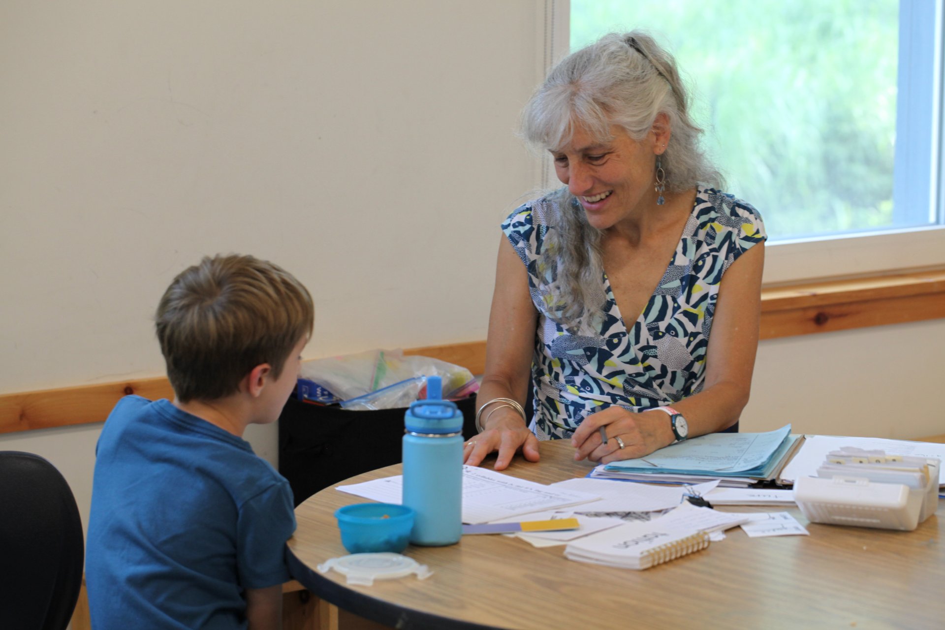 A tutor smiling with a student during a one-on-one lesson