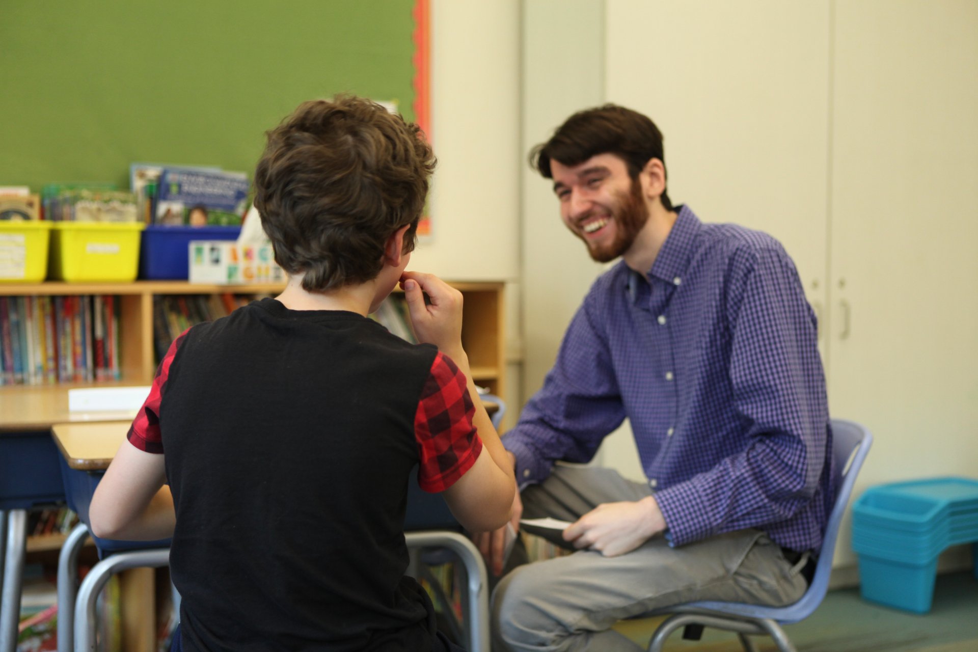 A clinician smiling with a student during a one-on-one session
